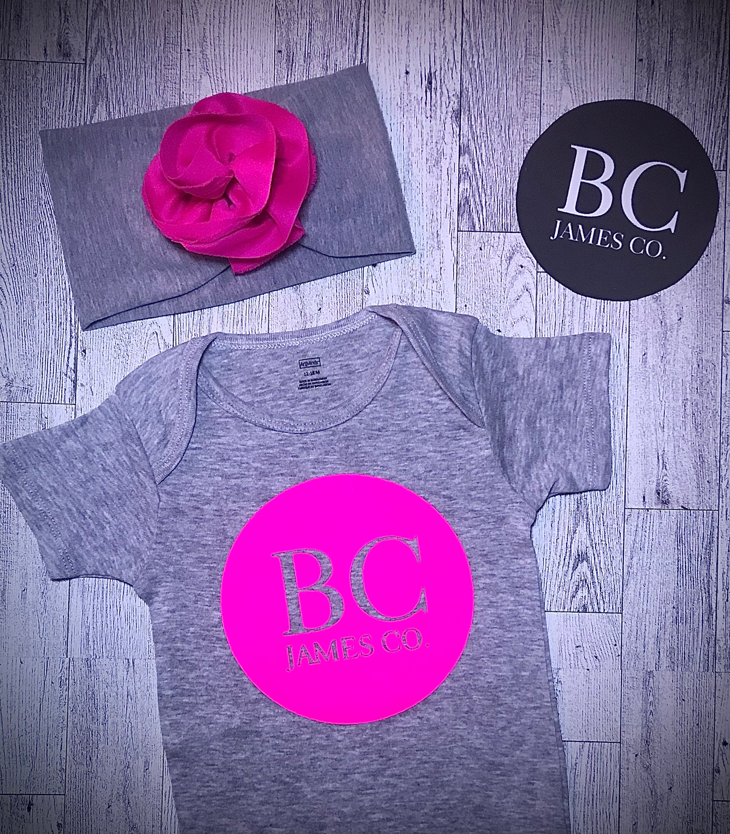 B.C JAMES CO. onesie with a matching flower style headband